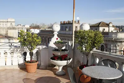 a balcony with two tables and a view of the city at Hotel Genio in Rome