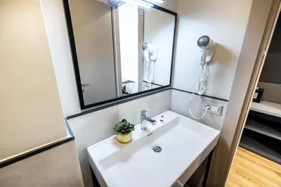 a bathroom with a white sink and a mirror at The Cross Hotel in Rome