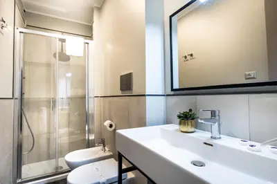 a bathroom with a sink and a shower and a toilet at The Cross Hotel in Rome