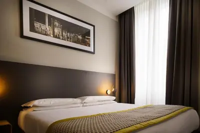 a bedroom with a bed and a large window at The Cross Hotel in Rome