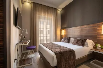 a hotel room with a bed and a television at The Republic in Rome