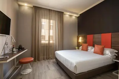 a hotel room with a large bed and a window at The Republic in Rome