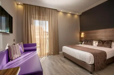 a hotel room with a bed and a couch at The Republic in Rome