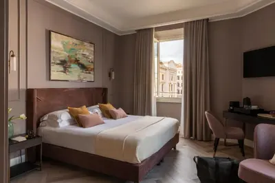a hotel room with a large bed and a window at Hotel Viminale in Rome