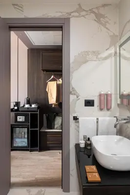 a bathroom with a white sink and a counter at Hotel Viminale in Rome