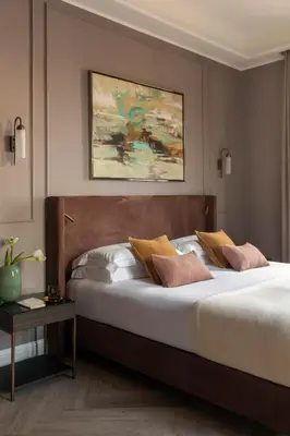 a bedroom with a large bed with white sheets and pillows at Hotel Viminale in Rome