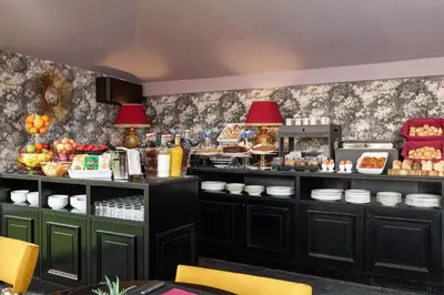 a restaurant with a counter with food on it at Hotel Barberini in Rome