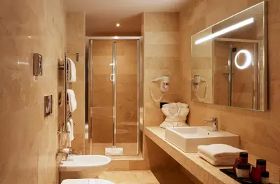 a bathroom with a sink and a shower and a toilet at The Code Hotel in Rome