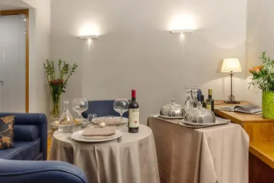 a table with wine bottles and glasses on it at The Code Hotel in Rome