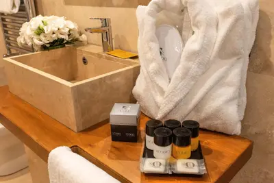 a bathroom with a counter with a sink and a towel at The Code Hotel in Rome