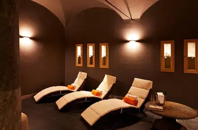 a waiting room with four white chairs and a table at The Code Hotel in Rome
