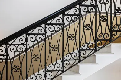 a stair railing with black wrought iron railings at Hotel Coppede' in Rome