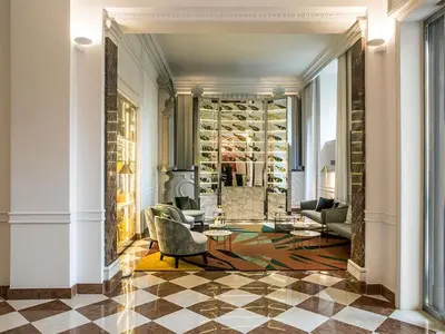 a bathroom with a tub and a bedroom with a bed at Sofitel Roma Villa Borghese in Rome
