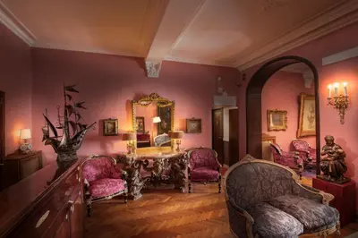 a room with a table and chairs and a mirror at Residenza Frattina in Rome
