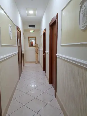 a hallway with a tile floor and a hallway with doors at Hotel Mirage in Rome