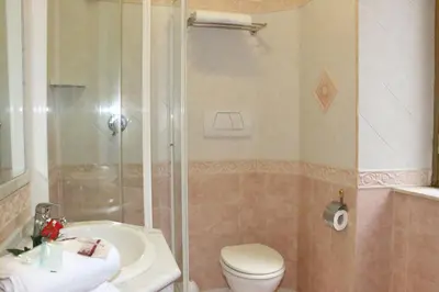 a bathroom with a shower and a toilet and a sink at Hotel Mirage in Rome