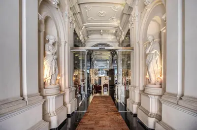 a hand holding a card with a building on it at La Griffe Hotel Roma in Rome