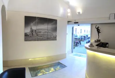 a lobby of a building with a picture on the wall at Hotel Elide in Rome