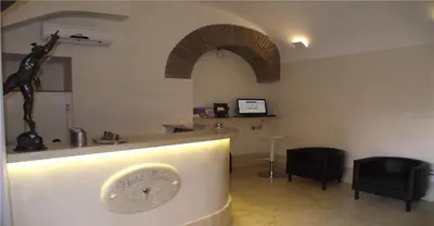a living room with a clock on a wall at Hotel Elide in Rome