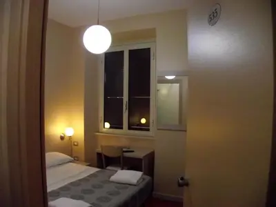 a small room with a bed and a window at Hotel Elide in Rome