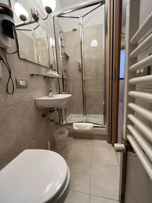 a bathroom with a shower and a toilet and a sink at Hotel Elide in Rome