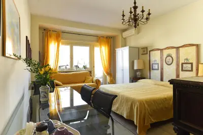 a bedroom with a bed and a couch at B&B All'Ombra di San Pietro in Rome