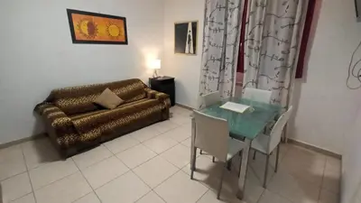 a living room with a couch and a table at Olimpo Apartments St John in Lateran in Rome