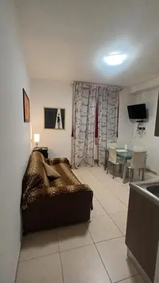 a living room with a couch and a table at Olimpo Apartments St John in Lateran in Rome