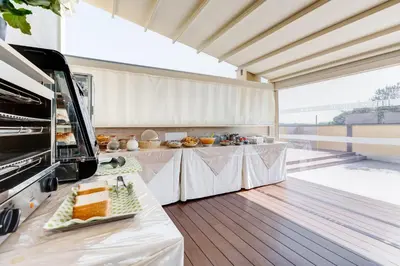 a large kitchen with two tables with food on it at Romoli Hotel in Rome