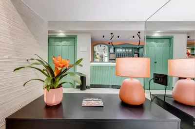 two lamps on a table with a plant on it at Romoli Hotel in Rome