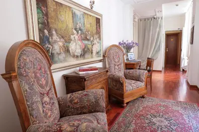 a living room with two chairs and a painting on the wall at Hotel Sant'Angelo in Rome