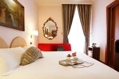 a hotel room with a white bed with a mirror at Hotel Sant'Angelo in Rome