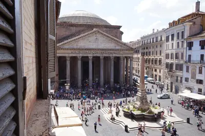 a crowd of people walking in front of a building at Antico Albergo del Sole al Pantheon in Rome