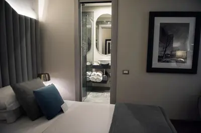 a hotel room with a bed and a mirror at Antico Albergo del Sole al Pantheon in Rome