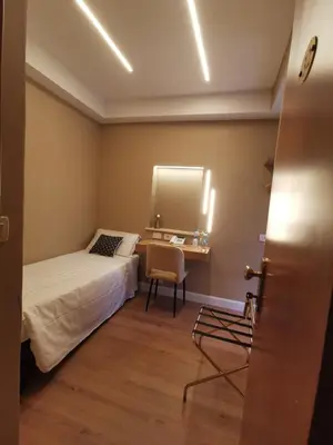 a hotel room with a bed and a desk and a table at Hotel Fiori in Rome