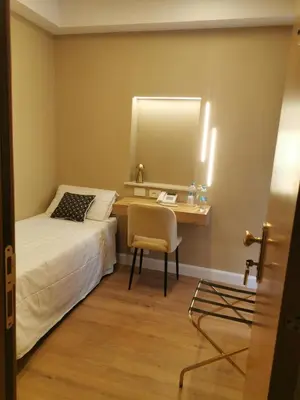 a bedroom with a desk and a bed and a mirror at Hotel Fiori in Rome