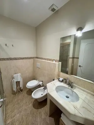 a bathroom with a sink and a toilet and a mirror at My Monti Place in Rome
