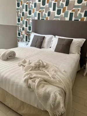 a bedroom with a bed with white sheets and pillows at My Monti Place in Rome