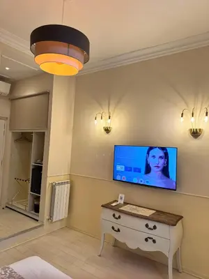 a living room with a television on a wall at My Monti Place in Rome