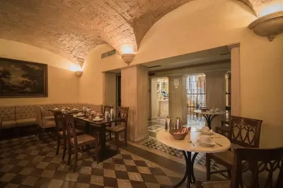 a restaurant with tables and chairs in a room at Hotel Donatello in Rome