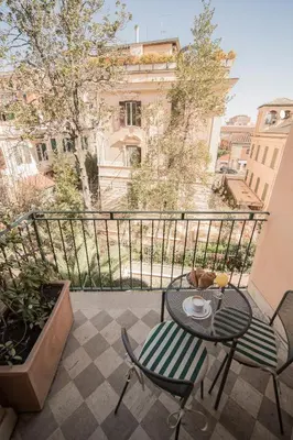 a patio with two chairs and a table with a cup of coffee at Hotel Donatello in Rome