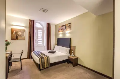 a hotel room with a bed and a desk at Hotel Rinascimento in Rome