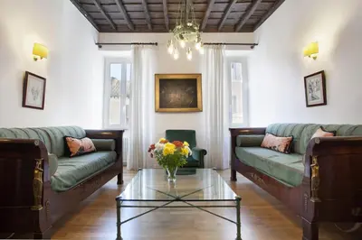 a living room with two couches and a glass table at Colosseo et Esquilino - LOCAPPART in Rome