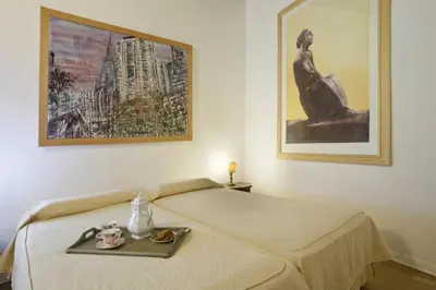 a bed in a room with a picture on the wall at Colosseo et Esquilino - LOCAPPART in Rome