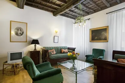 a living room with a couch and chairs and a tv at Colosseo et Esquilino - LOCAPPART in Rome