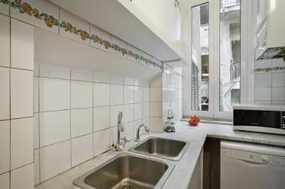 a kitchen with a sink and a window at Colosseo et Esquilino - LOCAPPART in Rome