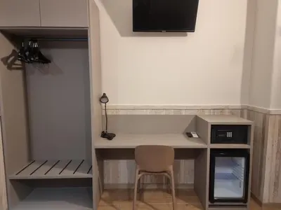 a desk with a chair in a room at Hotel Pyramid in Rome