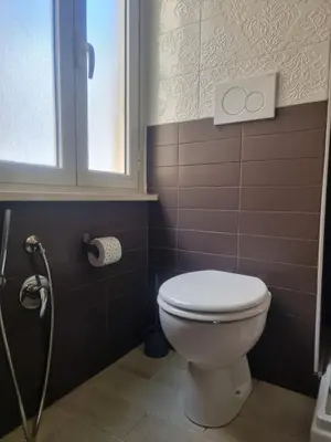a bathroom with a toilet and a window at Hotel Pyramid in Rome