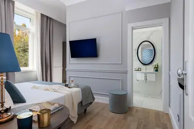 a hotel room with a bed and a mirror at Hotel La Ville Rome in Rome