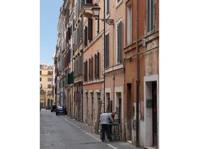 a man standing on a street in an alley at Golden Tulip Rome Piram in Rome